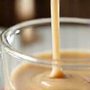 Macro shot of oat milk being poured